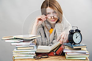 Girl student with glasses reading books