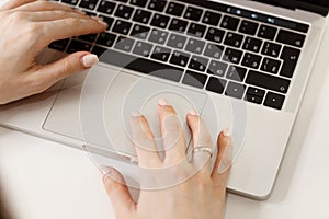 A girl student learning distance training course study work at home office. Young women`s hands typing on a laptop, close-up