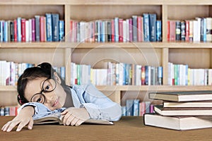 Girl student sleeping in the library