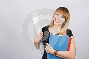 Girl student smiling and holding blueprints and a folder with documents