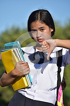 Girl Student With Thumbs Down Wearing Uniform With Books