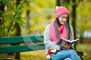 girl students read book in yellow autumn park