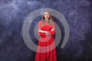 Girl in the studio posing in front of a photo camera