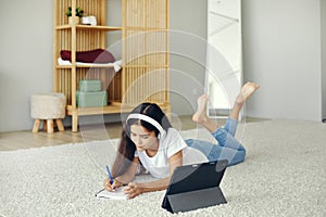 Girl studying online using modern tech at home