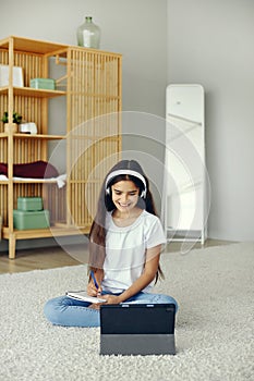 Girl studying online using modern tech at home