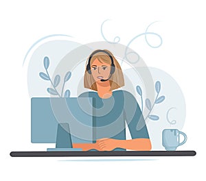 Girl while studying or working at the computer. With a cup of coffee in headphones with a microphone. Woman call center
