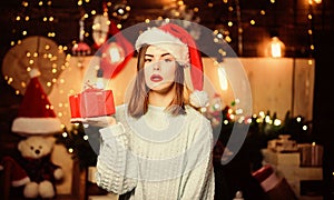 Girl stylish makeup red lips making christmas wish. Cozy christmas atmosphere. Believe in miracle. Woman santa claus hat