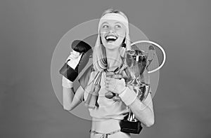 Girl successful modern woman hold golden goblet of sport champion and equipment blue background. How to find time for