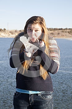 Girl sucking on a big piece of ice on frozen lake