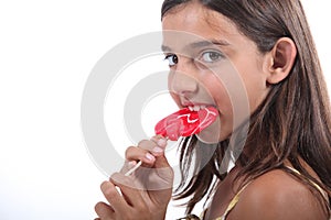 Girl sucking on a lollipop