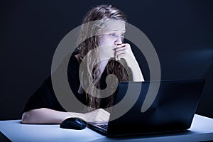 Girl suffering from electronic aggression photo