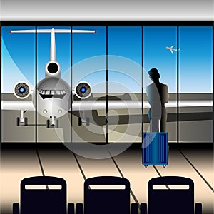 A girl with a suitcase at the airport looks at the plane through a large window