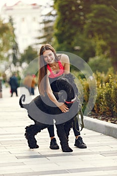 Girl in a summer city with dog