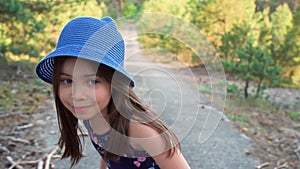 Girl in a summer dress runs in a pine forest