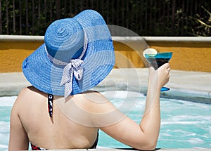 Girl in summer hat in jacuzzi (hot tub)
