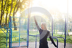 The girl on the summer sports ground does a workout. Healthy lifestyle. Athletic field