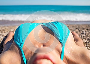 The girl sunbathes on the beach