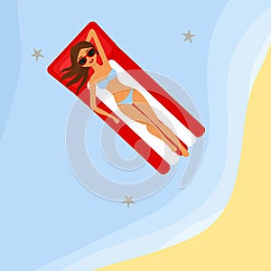 The girl is sunbathing on an air mattress