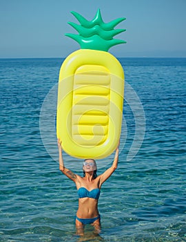 Girl sunbathing on beach with air mattress. Sexy woman on Caribbean sea in Bahamas. Summer vacation and travel to ocean