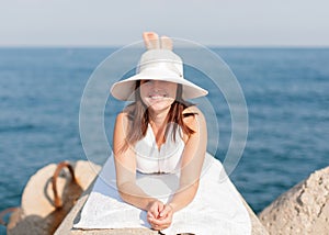 Girl sunbathing on breakwater