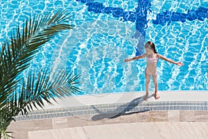 Girl sunbathing on the edge of the pool