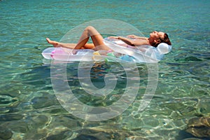 A girl sunbathing on a mattress