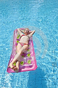 Girl sunbathing on a mattress