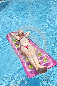 Girl sunbathing on a mattress photo