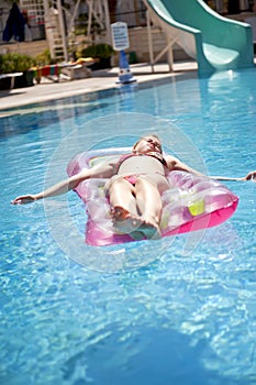 Girl sunbathing on a mattress photo