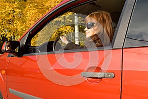 The girl with sunglass in the red car photo