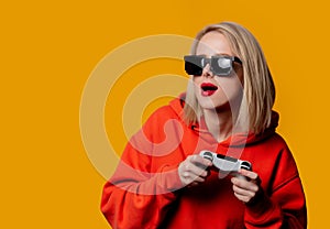 Girl in sunglasses keen plays with a joystick