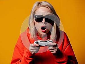 Girl in sunglasses keen plays with a joystick