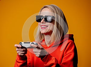 Girl in sunglasses keen plays with a joystick