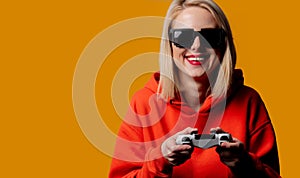 Girl in sunglasses keen plays with a joystick