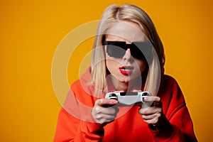 Girl in sunglasses keen plays with a joystick