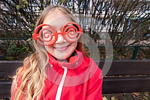 Girl with sunglasses and red jacket