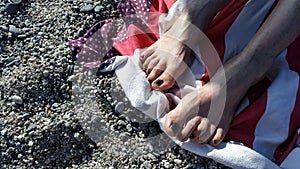 Girl sunny feet details on a towel