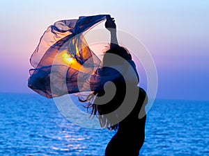 Girl on sunset background.