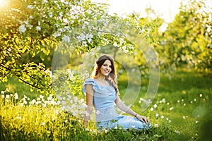 Girl at sunset in a flowering garden