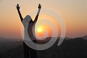 The girl at sunset. The girl stands with her back on the top of