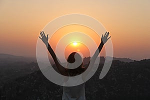 The girl at sunset. The girl stands with her back on the top of