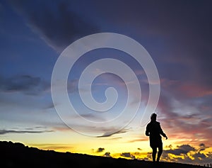 Girl at Sunset on a mountain ridge.