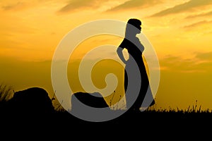 Girl on Sunset rock - Silhouette