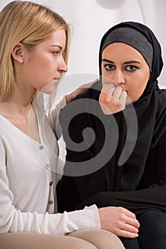 Girl supporting arab woman