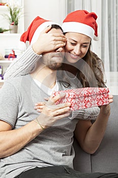 Girl suprise boyfriend with christmas gift