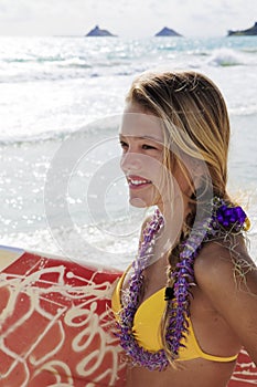 Girl with surfboard at kailua beach