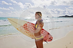 Girl with surfboard at kailua beach