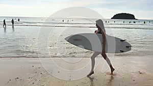 Girl Surfer Running Along The Sea With Surf Board