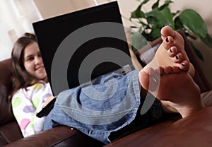 Girl surfing the internet with feet up