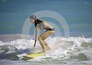 Girl surfing at Kailua Beach